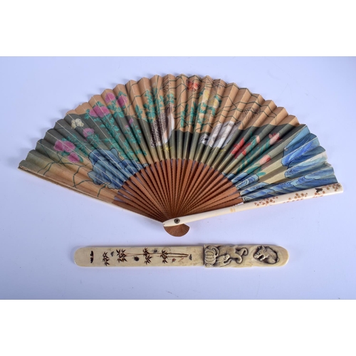 1492 - A 19TH CENTURY JAPANESE MEIJI PERIOD CARVED IVORY AND SILK FAN together with a similar Meiji paper k... 