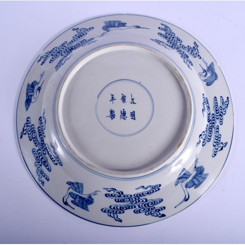 1499 - A 19TH CENTURY CHINESE BLUE AND WHITE PORCELAIN PLATE Qing, painted with Buddhistic figures. 24.5 cm... 