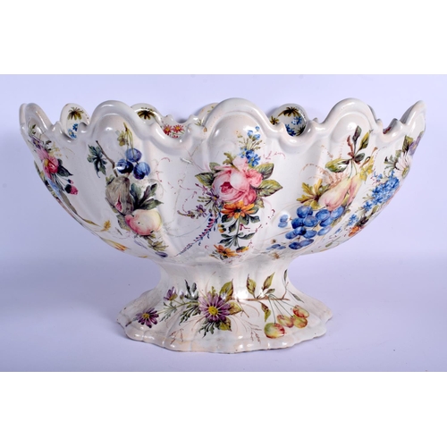 153 - A LARGE 18TH/19TH CENTURY EUROPEAN FAIENCE TIN GLAZED BOWL painted with flowers. 42 cm x 26 cm.