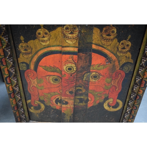 1557 - AN 18TH/19TH CENTURY TIBETAN PAINTED WOOD HANGING TORAM decorated with a fierce Buddhistic portrait,... 