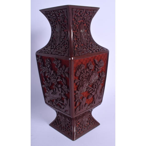 1576 - AN EARLY 20TH CENTURY CHINESE CARVED CINNABAR LACQUER VASE Qing, decorated with flowers. 24 cm high.