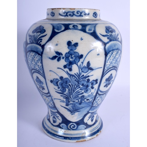 162 - AN 18TH CENTURY DUTCH BLUE AND WHITE TIN GLAZED VASE painted with flowers. 24 cm high.