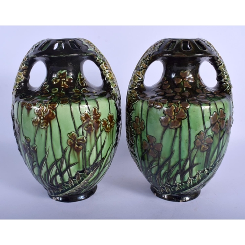 168 - A PAIR OF ART NOUVEAU AUSTRIAN TWIN HANDLED MAJOLICA TYPE VASES painted with flowers. 24 cm high.