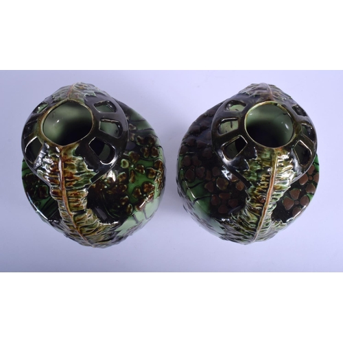 168 - A PAIR OF ART NOUVEAU AUSTRIAN TWIN HANDLED MAJOLICA TYPE VASES painted with flowers. 24 cm high.