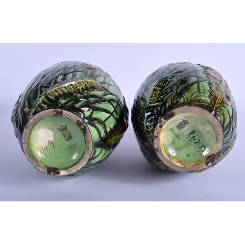 168 - A PAIR OF ART NOUVEAU AUSTRIAN TWIN HANDLED MAJOLICA TYPE VASES painted with flowers. 24 cm high.