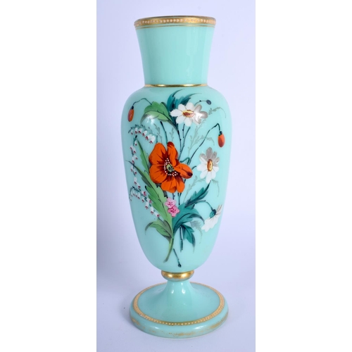 17 - A LATE VICTORIAN ENAMELLED GREEN GLASS VASE painted with flowers. 20 cm high.