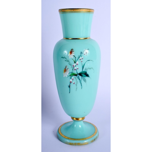 17 - A LATE VICTORIAN ENAMELLED GREEN GLASS VASE painted with flowers. 20 cm high.