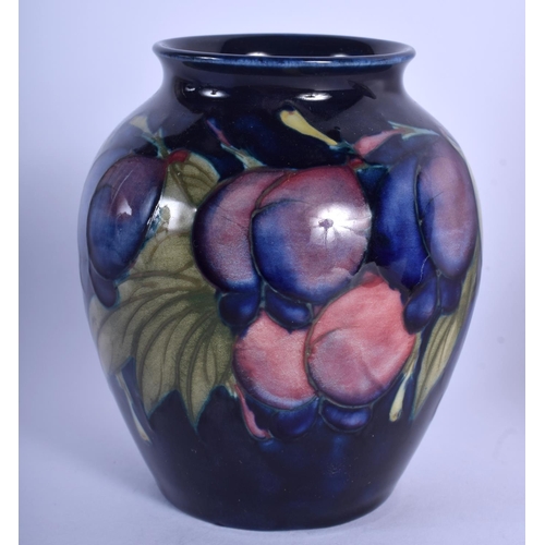 190 - A MOORCROFT VASE together with a tile. Largest 15 cm square. (2)