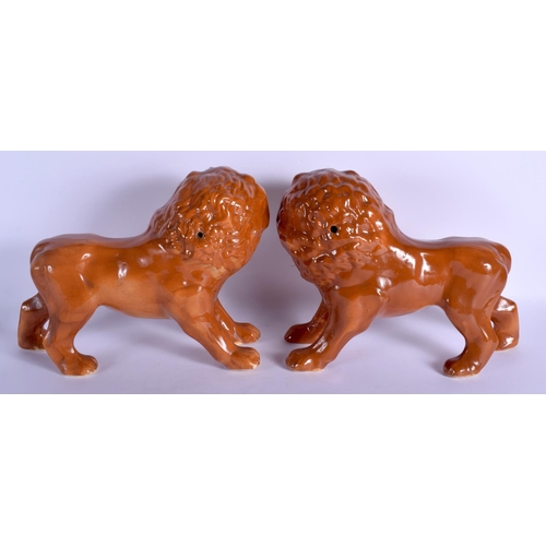 193 - A LARGE PAIR OF 19TH CENTURY CONTINENTAL POTTERY FIGURES OF LIONS. 34 cm x 28 cm.