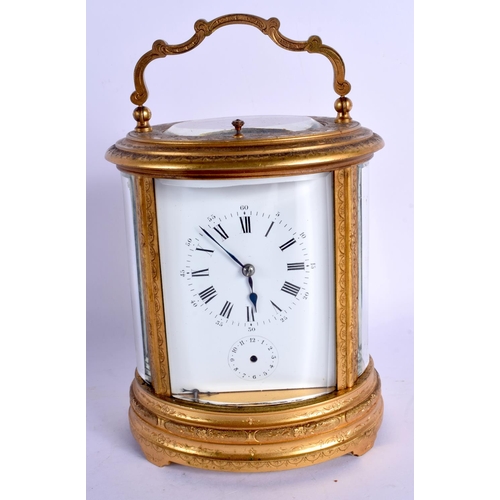 2017 - A LARGE ANTIQUE FRENCH OVAL REPEATING BRASS CARRIAGE CLOCK decorated with foliage. 21 cm high inc ha... 