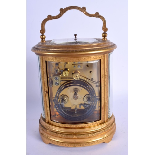 2017 - A LARGE ANTIQUE FRENCH OVAL REPEATING BRASS CARRIAGE CLOCK decorated with foliage. 21 cm high inc ha... 