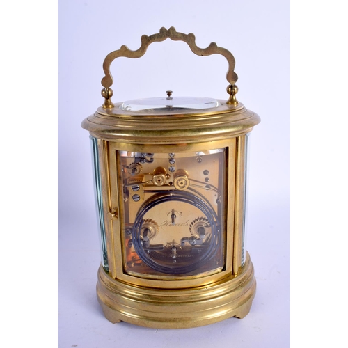 2019 - AN EARLY 20TH CENTURY FRENCH BRASS OVAL REPEATING CARRIAGE CLOCK inset with an enamel panel of roman... 