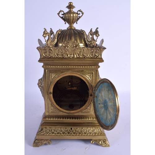 2038 - A 19TH CENTURY FRENCH BRASS MANTEL CLOCK with bold circular dial, within a case decorated with cheru... 