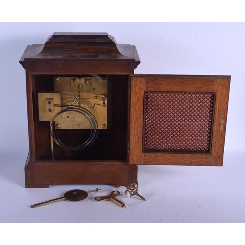 2044 - AN EARLY 20TH CENTURY OAK J W BENSON OF LONDON with silvered dial. 32 cm x 22 cm.