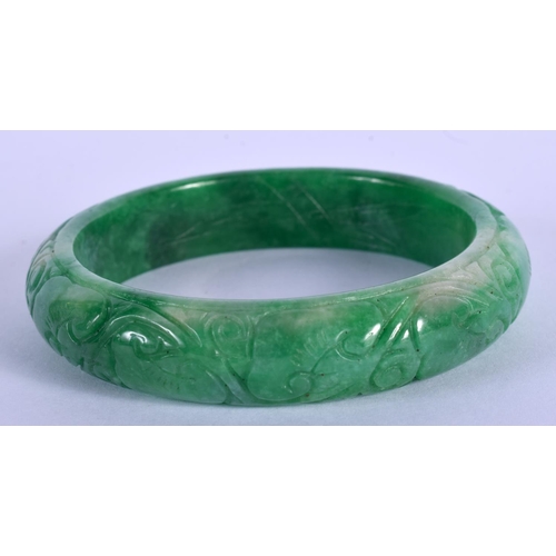 2132 - A CHINESE APPLE JADE BANGLE 20th Century. 7.5 cm wide.