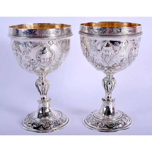 2174 - AN ANTIQUE CONTINENTAL SILVER DOUBLED ENDED STACKING CUPS possibly for wagering, decorated with putt... 