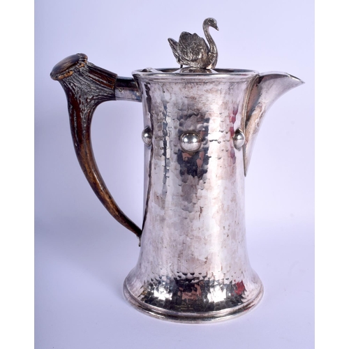 2175 - AN ARTS AND CRAFTS HAMMERED SILVER PLATED SWAN TEAPOT with horn handle. 22.5 cm high.