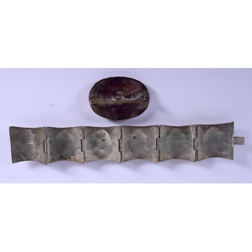 2213 - A CHINESE CINNABAR BRACELET and a similar brooch. (2)