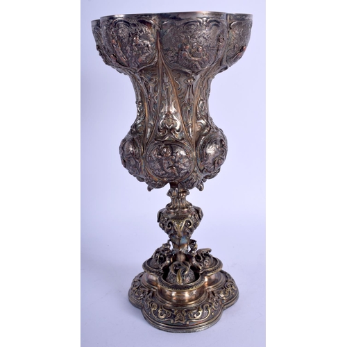 2260 - A 19TH CENTURY CONTINENTAL SILVER PLATED GOBLET decorated with serpents, figures etc. 22 cm high.