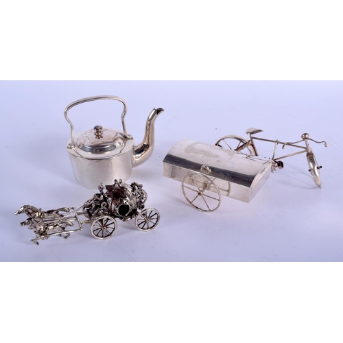 2261 - A NOVELTY SILVER TEAPOT AND COVER together with two silver carriages. 177 grams. (3)