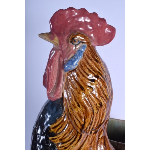 2302 - A LARGE 19TH CENTURY CONTINENTAL MAJOLICA FIGURE OF A ROAMING COCK modelled upon a naturalistic base... 