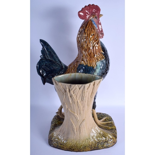 2302 - A LARGE 19TH CENTURY CONTINENTAL MAJOLICA FIGURE OF A ROAMING COCK modelled upon a naturalistic base... 