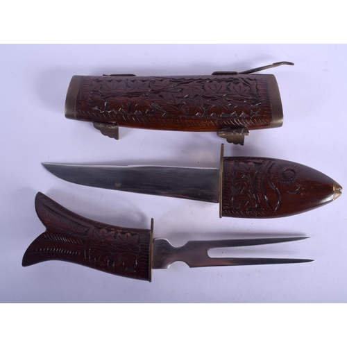 2305 - A RARE EARLY 20TH CENTURY EUROPEAN CARVED WOOD CASED KNIFE AND FISH FORK. 35 cm long.