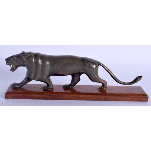 2327 - A 19TH CENTURY CONTINENTAL CARVED RHINOCEROS HORN LION modelled upon a plinth. 16 cm wide.