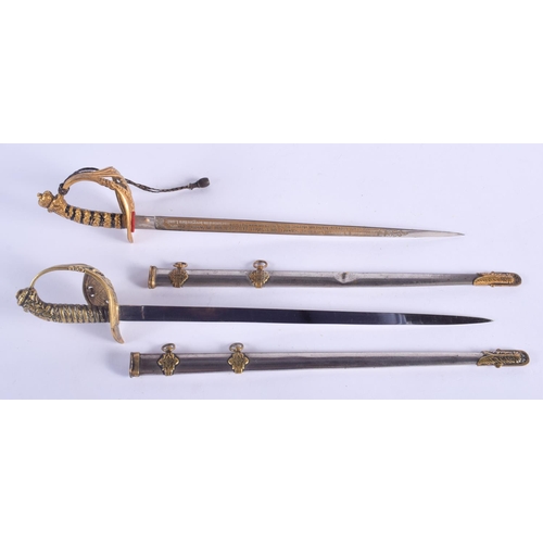 2366 - A PAIR OF EARLY 20TH CENTURY NOVELTY LETTER OPENERS in the form of naval swords. 30 cm long.