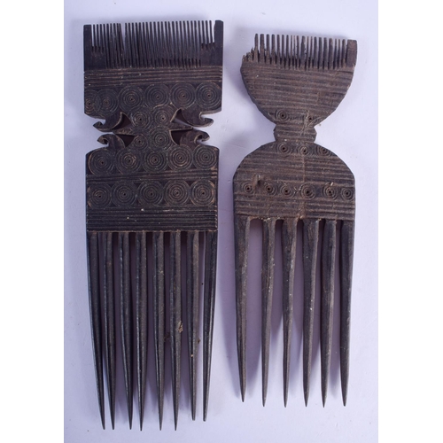 2376 - A PAIR OF EARLY 20TH CENTURY TRIBAL COMBS decorated with motifs. 18.5 cm long.