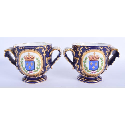 2379 - A PAIR OF 19TH CENTURY FRENCH SEVRES TWIN HANDLED PORCELAIN CACHE POTS painted with armorials and po... 