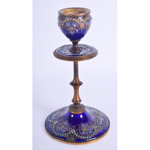 2394 - A 19TH CENTURY FRENCH ENAMELLED GILT METAL CANDLESTICK jewelled with turquoise. 15.5 cm high.