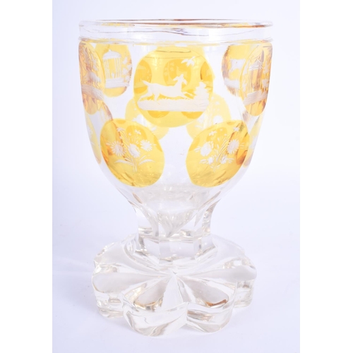 2396 - A 19TH CENTURY BOHEMIAN YELLOW AND CLEAR GLASS GOBLET decorated with gardens. 15 cm high.