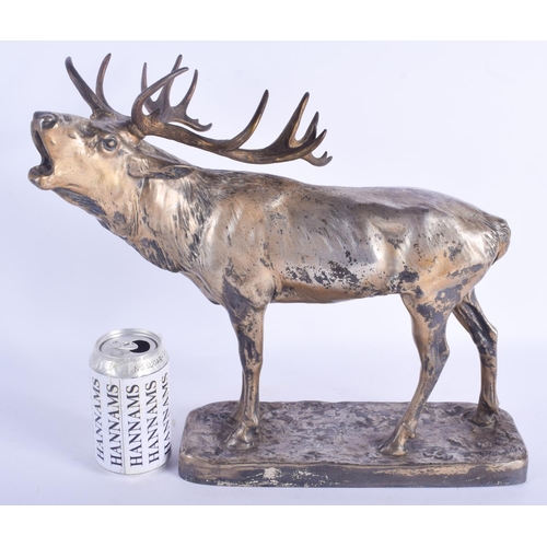 2424 - A LARGE ANTIQUE SILVERED BRASS FIGURE OF A ROAMING STAG modelled upon a rectangular base. 33 cm x 34... 