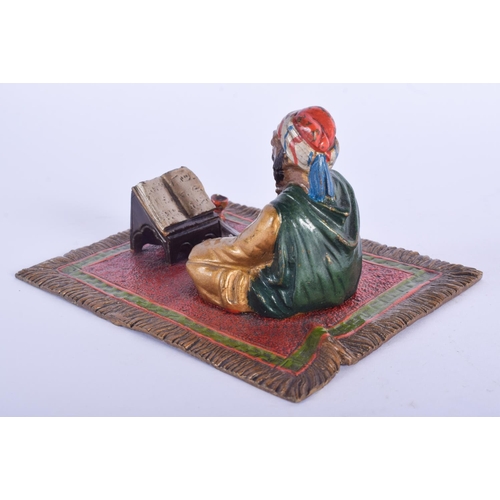 2438 - A 19TH CENTURY AUSTRIAN COLD PAINTED BRONZE FIGURE OF A SEATED MALE modelled upon a carpet. 12 cm x ... 