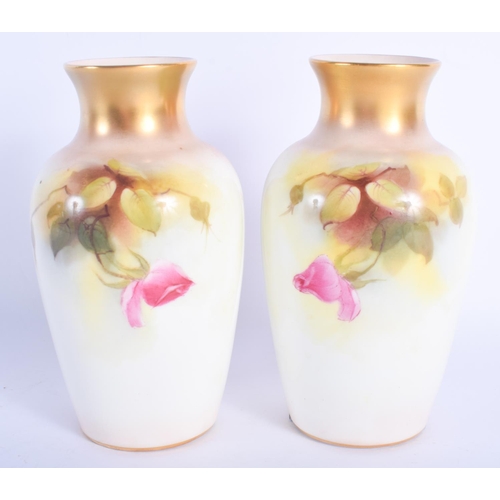 2454 - A PAIR OF ROYAL WORCESTER PORCELAIN VASES painted with pink roses. 15 cm high.