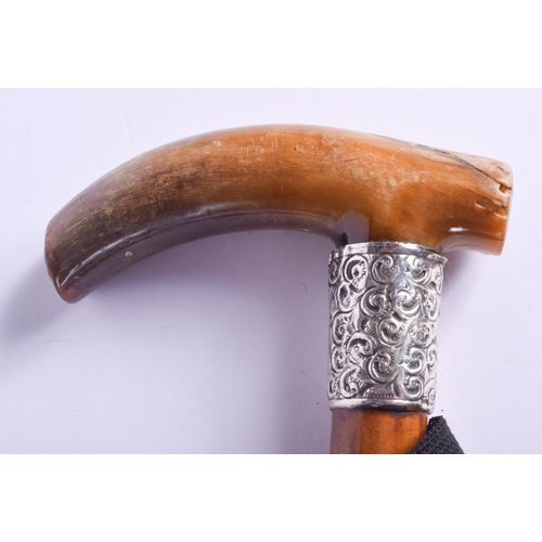 2457 - AN ANTIQUE SILVER MOUNTED RHINOCEROS HORN HANDLED WALKING CANE. 86 cm long.