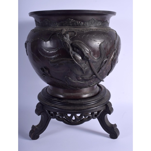 1013 - A 19TH CENTURY JAPANESE MEIJI PERIOD BRONZE JARDINIERE decorated with dragons. 27 cm x 21 cm.