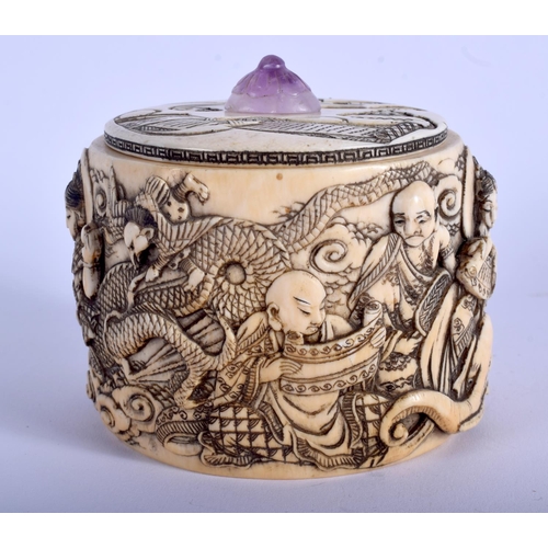 1028 - A 19TH CENTURY JAPANESE MEIJI PERIOD CARVED IVORY BOX AND COVER with amethyst finial, decorated with... 