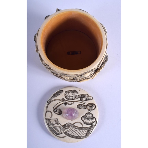 1028 - A 19TH CENTURY JAPANESE MEIJI PERIOD CARVED IVORY BOX AND COVER with amethyst finial, decorated with... 