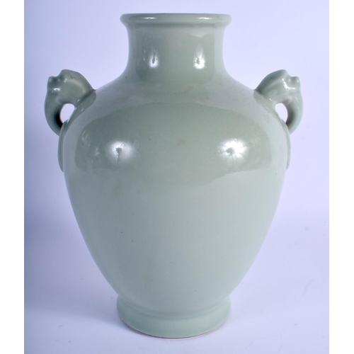 1041 - A CHINESE CELADON TWIN HANDLED PORCELAIN VASE bearing Qianlong marks to base. 24 cm x 14 cm.