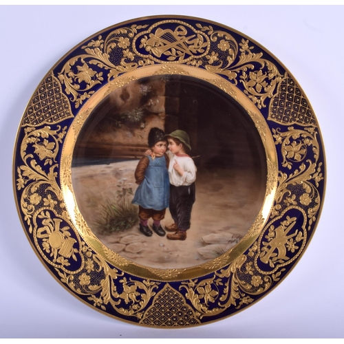 105 - A FINE VIENNA PORCELAIN CABINET PLATE painted with two children within a richly gilded border. 22 cm... 