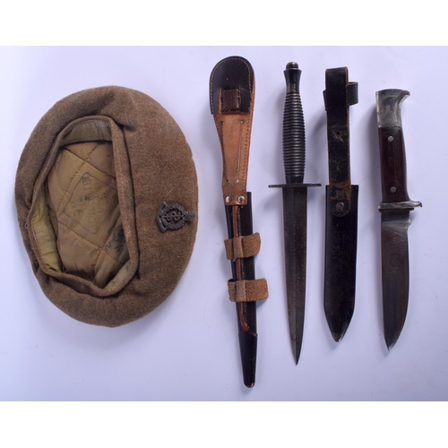 436 - TWO VINTAGE MILITARY BAYONETS together with a beret. (3)