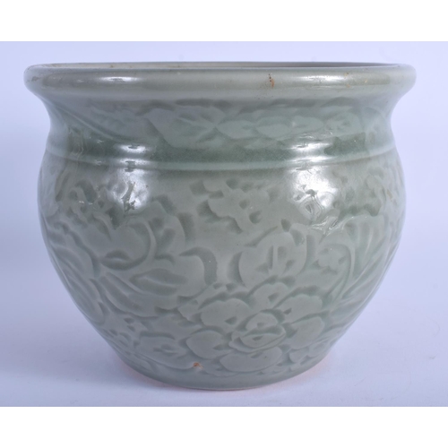 1069 - A 19TH CENTURY CHINESE CELADON POTTERY JARDINIERE decorated with foliage and vines. 13 cm x 16 cm.