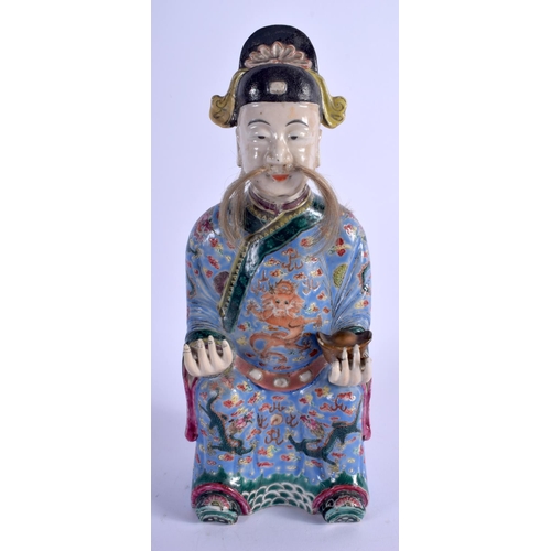 1090 - A 19TH CENTURY CHINESE FAMILLE ROSE PORCELAIN FIGURE OF AN IMMORTAL Late Qing, painted with dragons.... 