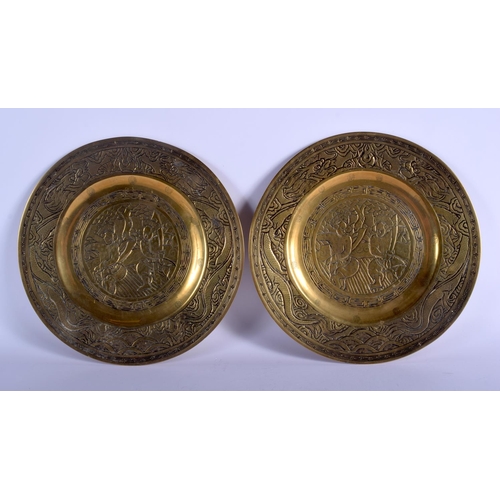 1102 - A PAIR OF 19TH CENTURY CHINESE BRONZE DISHES decorated with figures and dragons. 25 cm diameter.