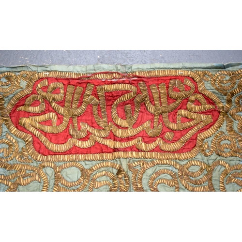 477 - AN OTTOMAN ISLAMIC SILK EMBROIDERY decorated with gilded scripture. 76 cm x 64 cm.