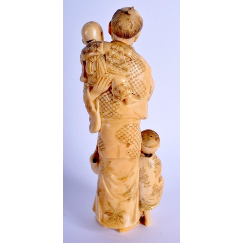 1133 - A 19TH CENTURY JAPANESE MEIJI PERIOD CARVED IVORY OKIMONO modelled as a male and two children holdin... 