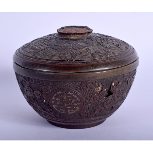 1134 - A CHINESE QING DYNASTY CARVED COCONUT BOX AND COVER decorated with motifs. 7.5 cm diameter.