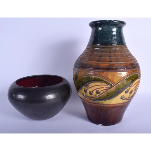 117 - A STYLISH ARTS AND CRAFTS POTTERY VASE together with a jarlet. Largest 30 cm high. (2)